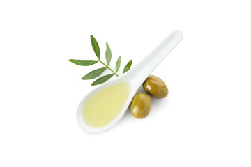 Ceramic spoon with olive oil, olives and leaves isolated on white background