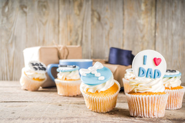 Happy Father’s Day greeting card.  Greetings and presents for Dad's day - gift box, coffee tea cup, tie, homemade special cupcakes.