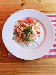 A dish of different vegetables in a plate in a restaurant.
