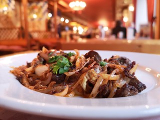 Roasted liver with onions and mashed potatoes in a restaurant.