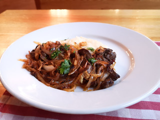 Roasted liver with onions and mashed potatoes in a restaurant.