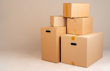 Pile of brown moxing boxes on grey background