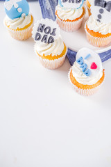 Happy Father’s Day greeting card.  Greetings and presents for Dad's day - gift box, coffee tea cup, tie, homemade special cupcakes.