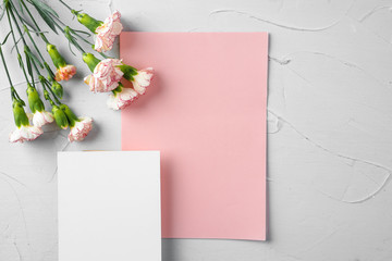 Top view of a pink paper letter and flowers with copy space
