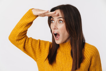 Image of excited adult woman looking aside with hand at her forehead
