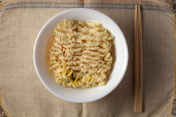 brewed noodles on a light burlap background
