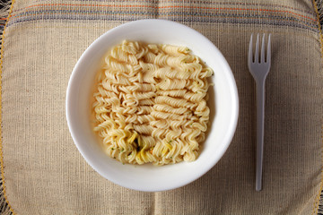 brewed noodles on a light burlap background