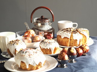 Easter baking with Easter eggs dyed with onion husks with imprints of fresh leaves, on a fabric canvas background. We meet Easter Sunday, tea drinking.