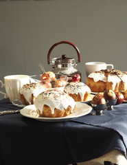 Easter baking with Easter eggs dyed with onion husks with imprints of fresh leaves, on a fabric canvas background. We meet Easter Sunday, tea drinking.