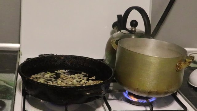 spaghetti cooking on gast stove with flame