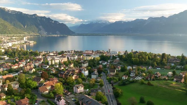 Magic hour aerial shot of Switzerland Montreux with view to Lake Geneva and Snowy Mountains top