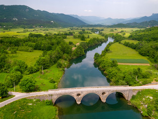 Fototapeta na wymiar Aerial view of the old stone bridge on the Lika River, Croatia