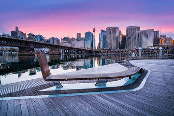 Sydney Tower Eye, View of Sydney skyline from Darling Harbour Bridge with colourful sunrise sky...