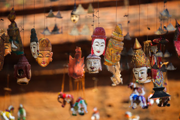 Bright souvenirs and puppets on the market in the ancient pagoda in Bagan, Myanmar - obrazy, fototapety, plakaty