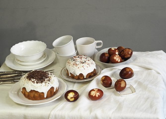 Easter baking with Easter eggs dyed with onion husks with imprints of fresh leaves, on a fabric canvas background. We meet Easter Sunday, tea drinking.