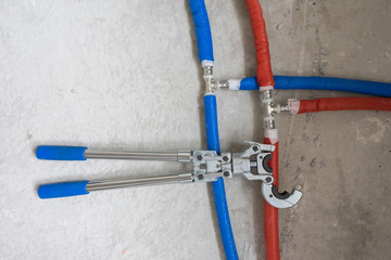 Plumbing copper pipe crimper press tube tool. Heating pipes connected by press fittings. Hydraulic,...