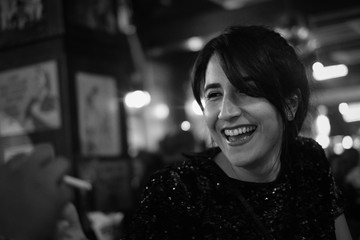 Black and white candid portrait of smiling beautiful young iranian persian girl