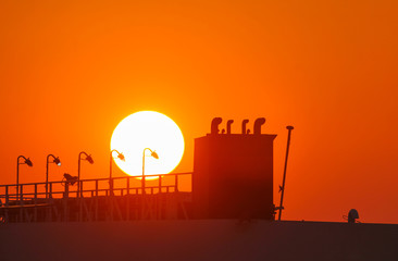 The departing ship in the rays of the sun