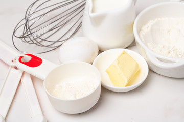 organic products milk, flour, eggs and butter on a white background