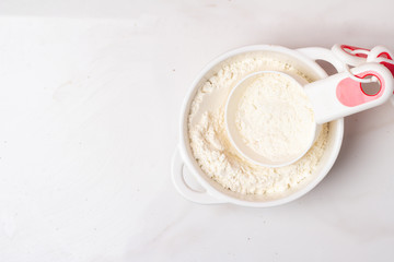 cup with flour on a white background