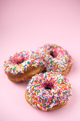 Fototapeta na wymiar Pink donuts on pink background