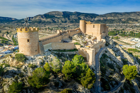 Aerial view of Castalla castle in Valencia province Spain with donjon towering over the town and a courtyard reinforced with a circular tower on a sunny day with blue sky ground plan