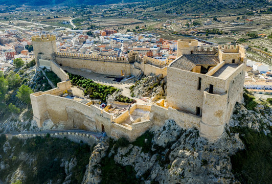 Aerial view of Castalla castle in Valencia province Spain with donjon towering over the town and a courtyard reinforced with a circular tower on a sunny day with blue sky ground plan