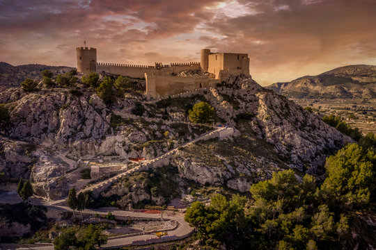 HIlltop Castalla castle near Alicante Spain with donjon and battered wall surrounding a courtyard