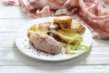 Baked chicken breast with spices and scrambled eggs with croutons