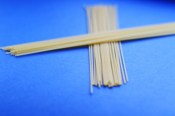 raw spaghetti on blue background