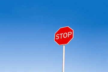 Stop sign against the blue sky.