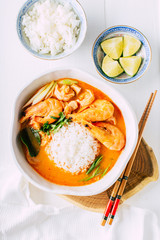 Tasty Tom Yam with shrimp and rice, spicy Thai soup, close-up