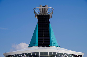 Turquoise funnel of MS Artania by Phoenix Seereisen with windows of panorama lounge of luxury...