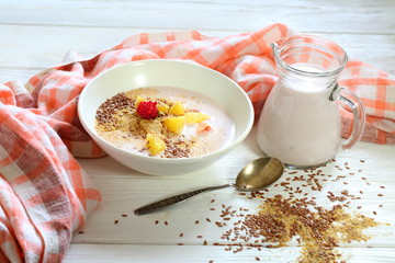 Yogurt with flax seeds, grapefruit, raspberries and orange on a white background