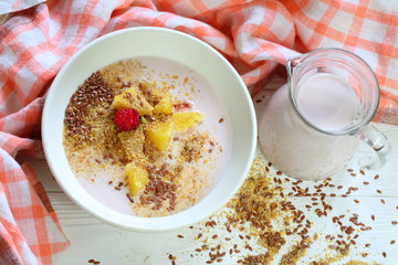 Yogurt with flax seeds, grapefruit, raspberries and orange on a white background