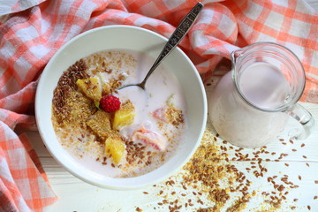 Yogurt with flax seeds, grapefruit, raspberries and orange on a white background