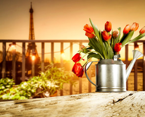 Wooden table of free space and blurred background of Paris city.Sunny day and orange color of sunset.