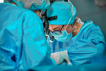 Surgeons team in the operating room, portraits close-up. modern operating, plastic surgery. Beauty...
