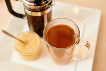 Tea with a teapot, cup and lemon jam. Natural fruit tea.