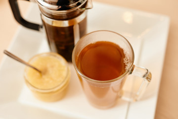 Tea with a teapot, cup and lemon jam. Natural fruit tea.