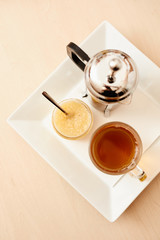 Tea with a teapot, cup and lemon jam. Natural fruit tea.