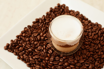 A cup of coffee in coffee beans. Coffee background