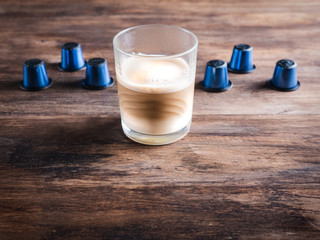 coffee capsules and a latte coffee