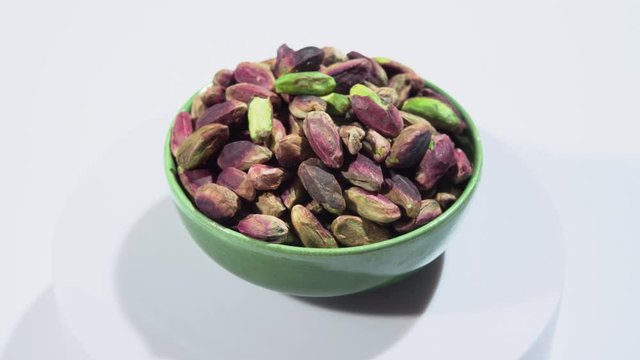 Rotation of emerald green pistachio nuts from Bronte, Sicily, Italy