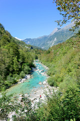 Fototapeta na wymiar The Soča, the most beautiful river in Slovenia. It springs from the heart of the Triglav National Park below the high peaks of the Julian Alps.