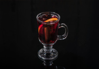 a hot drink in a glass on a dark background