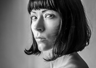 Portrait of angry young woman in black and white close up