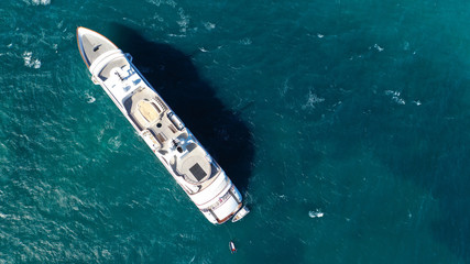 Fototapeta premium Aerial drone top down photo of luxury yacht docked in Mediterranean destination port with deep blue sea