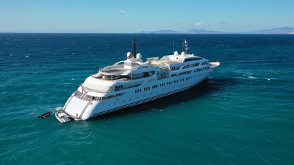 Fototapeta na wymiar Aerial drone top down photo of luxury yacht docked in Mediterranean destination port with deep blue sea