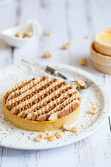 Delicious mini tarts with nuts and custard. Assortment of delicious and colorful dessert, salted...